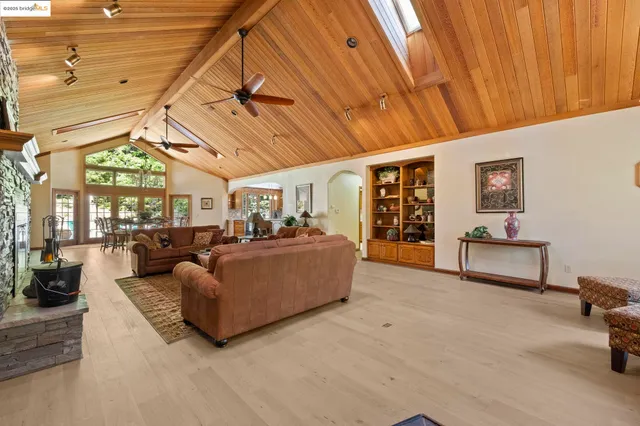 a living room with furniture a large window with table and chairs