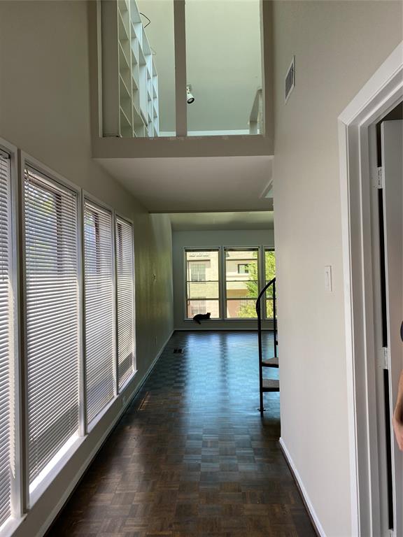 3936 Travis Street Dallas, TX 75204 - Photo 3 of 17 High ceilings accentuating a built-in bookcase on a mezzanine level