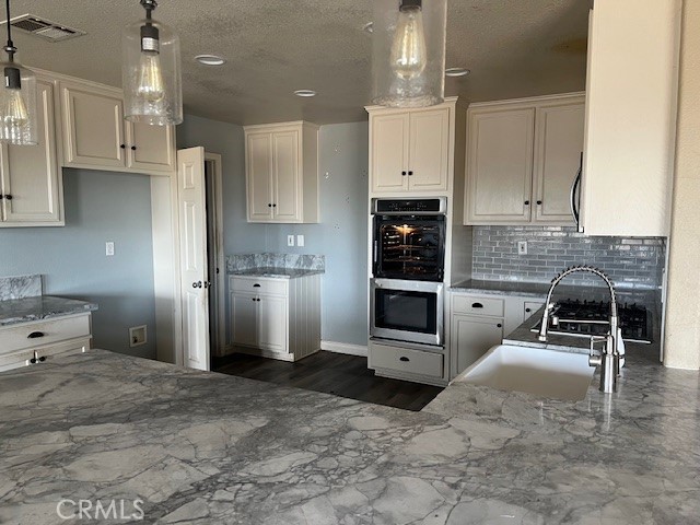 9951 Arrowhead Road Phelan, CA 92371 - Photo 12 of 21 a large kitchen with stainless steel appliances kitchen island granite countertop a refrigerator and cabinets