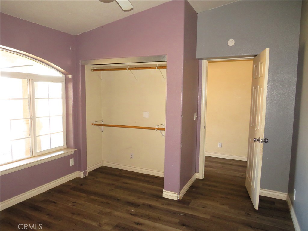 9951 Arrowhead Road Phelan, CA 92371 - Photo 16 of 21 a view of empty room with wooden floor and fan