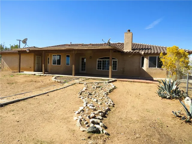 a view of empty room with wooden floor and fireplace