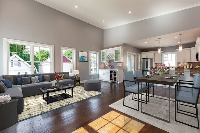 a living room with furniture wooden floor and a large window