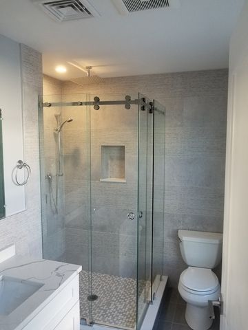 a bathroom with a shower a toilet and sink