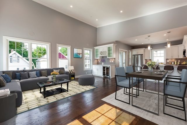 a living room with furniture wooden floor and a table