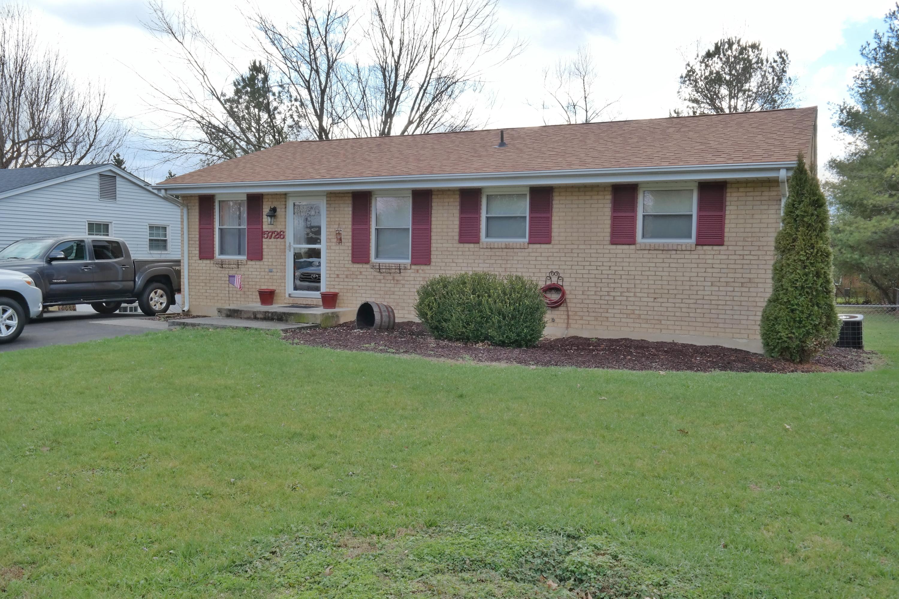 a front view of a house with a garden and yard