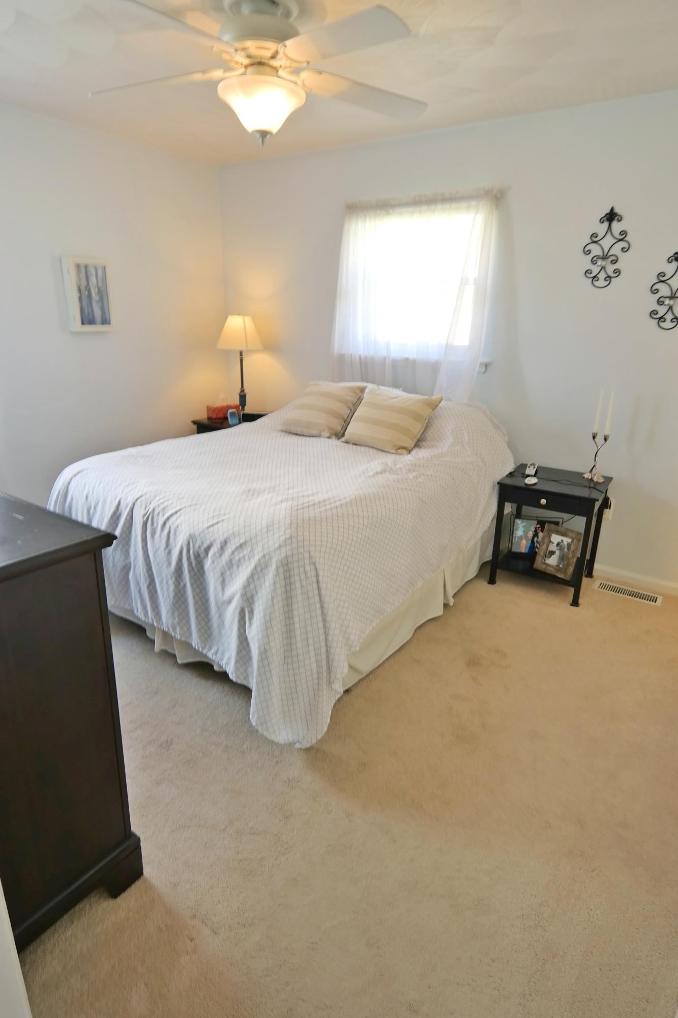 5726 Cove Road Roanoke, VA 24019 - Photo 15 of 34 a bedroom with a bed and a chair