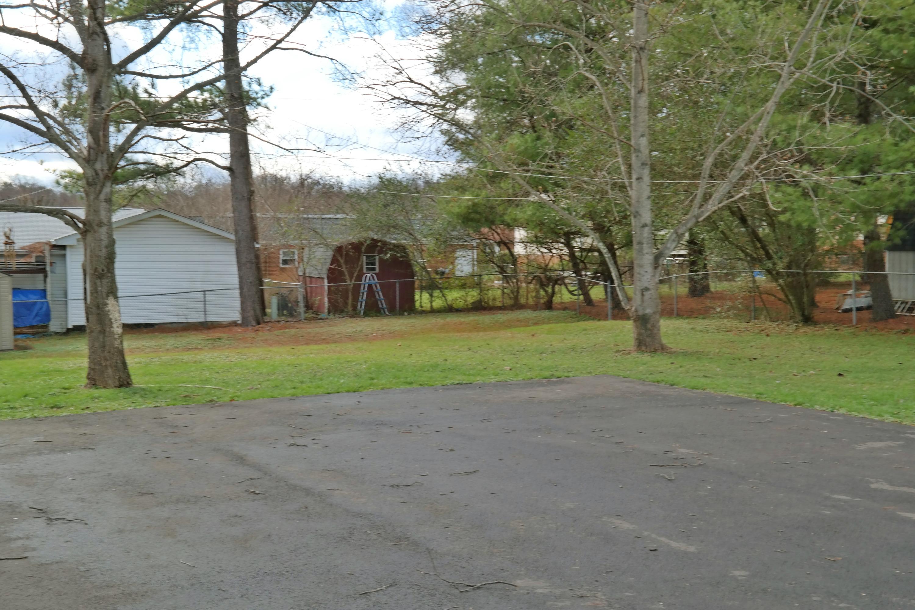 5726 Cove Road Roanoke, VA 24019 - Photo 33 of 34 a view of a house with a big yard and large trees