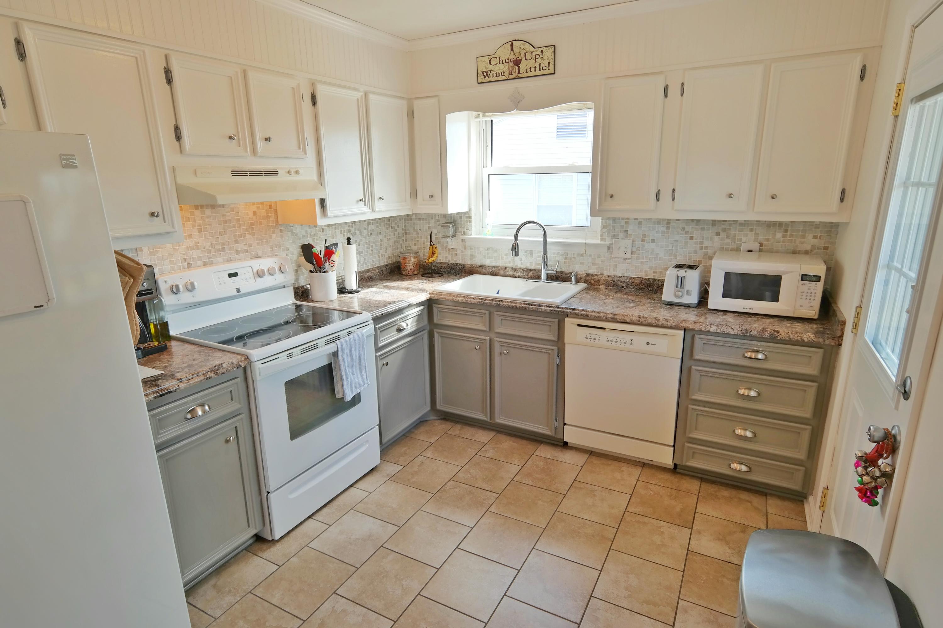5726 Cove Road Roanoke, VA 24019 - Photo 7 of 34 a kitchen with a stove sink and cabinets
