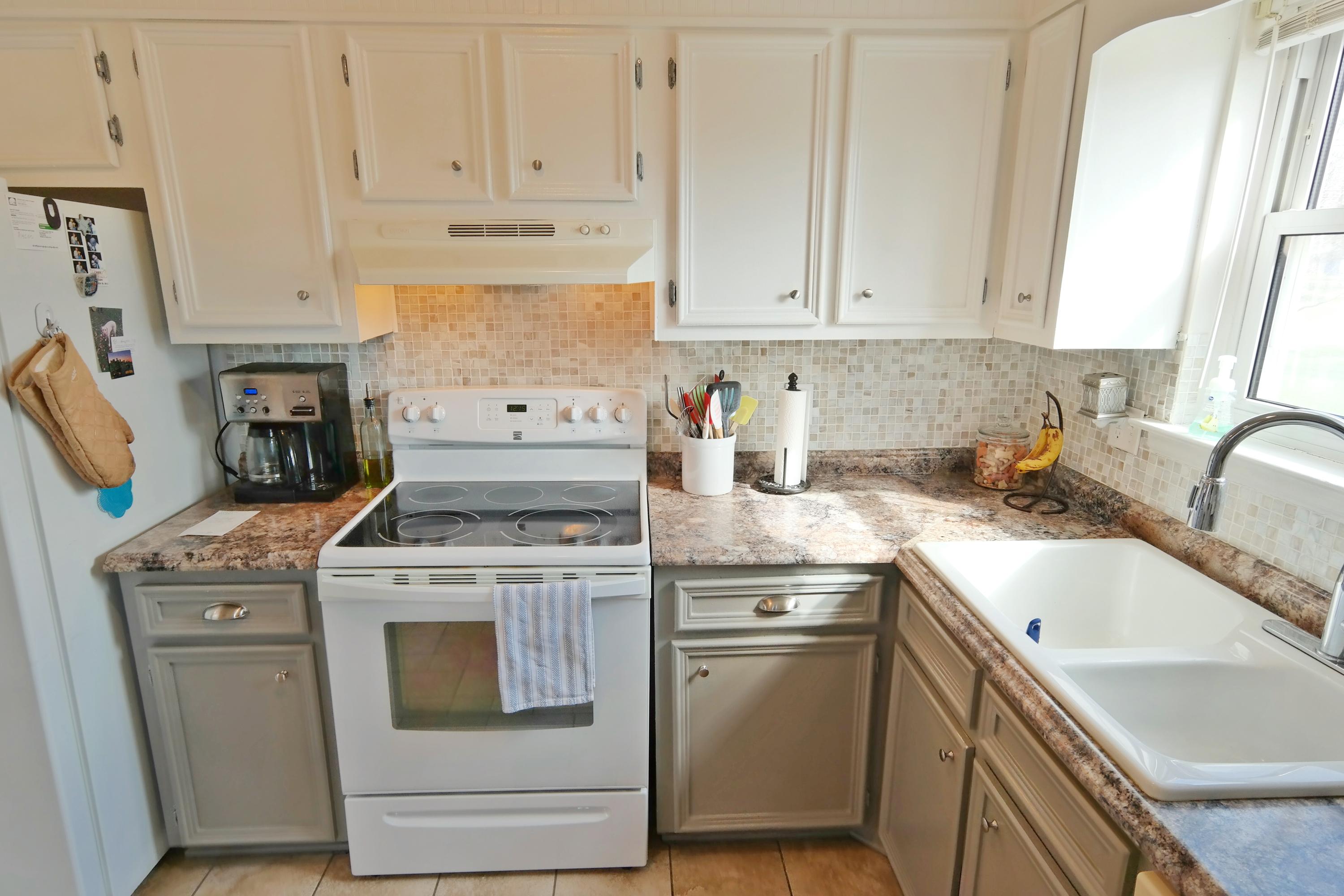 5726 Cove Road Roanoke, VA 24019 - Photo 8 of 34 a kitchen with granite countertop white cabinets and white appliances