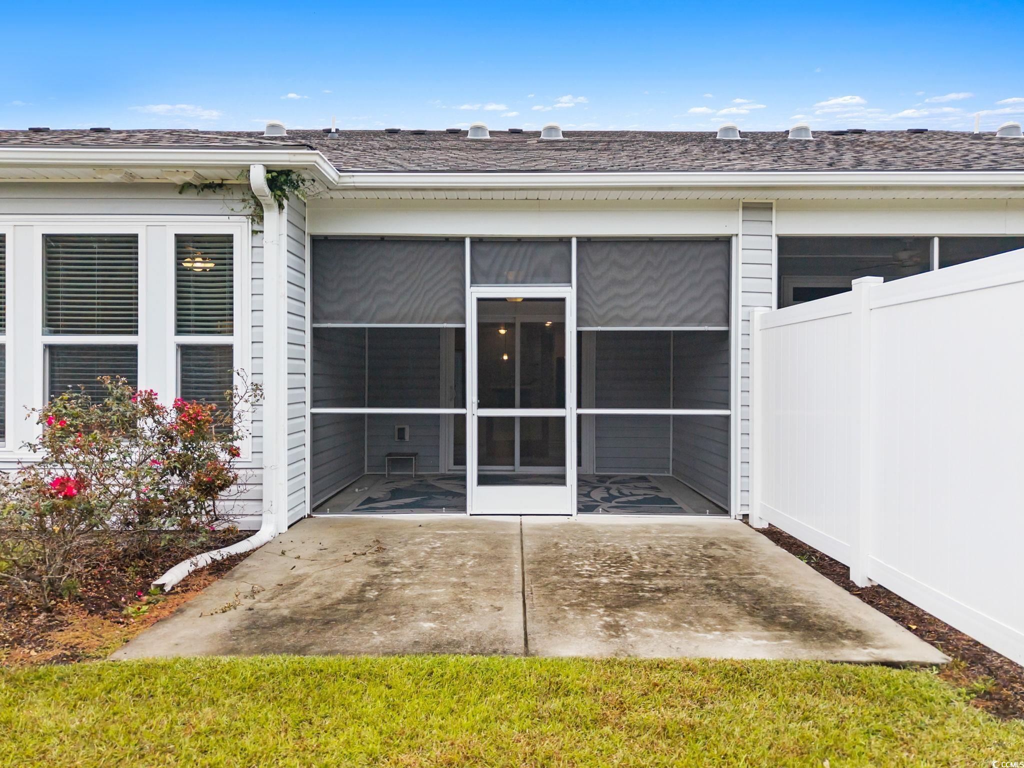 797 Salerno Circle, Unit C Myrtle Beach, SC 29579 - Photo 11 of 40 View of exterior entry with a sunroom and a shingled roof