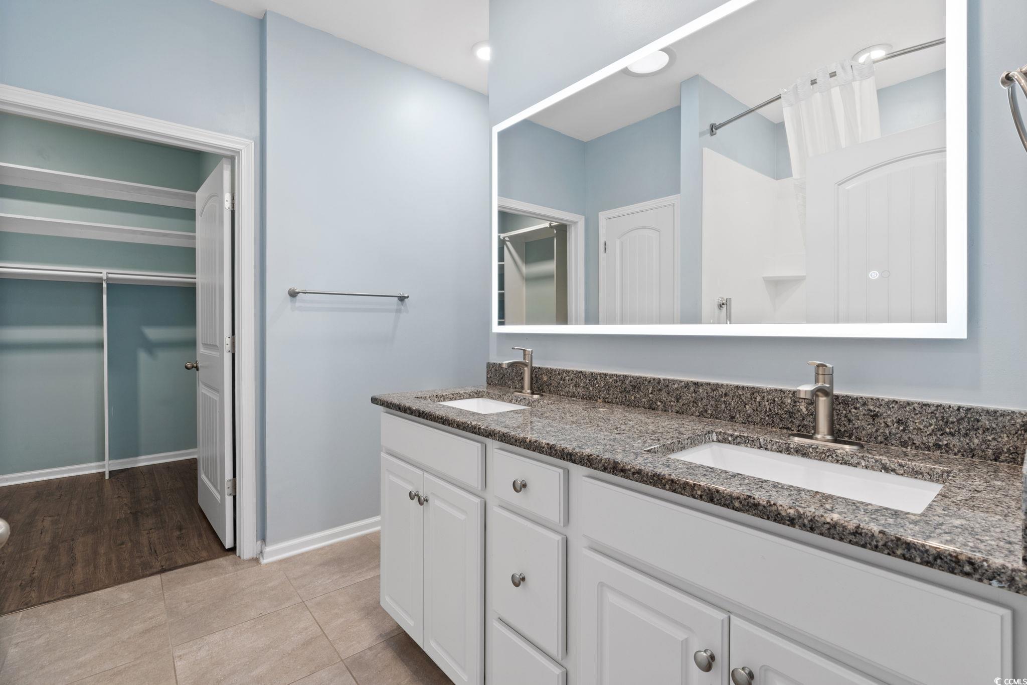797 Salerno Circle, Unit C Myrtle Beach, SC 29579 - Photo 15 of 40 Bathroom with a spacious closet, double vanity, light tile patterned floors, a shower, and recessed lighting