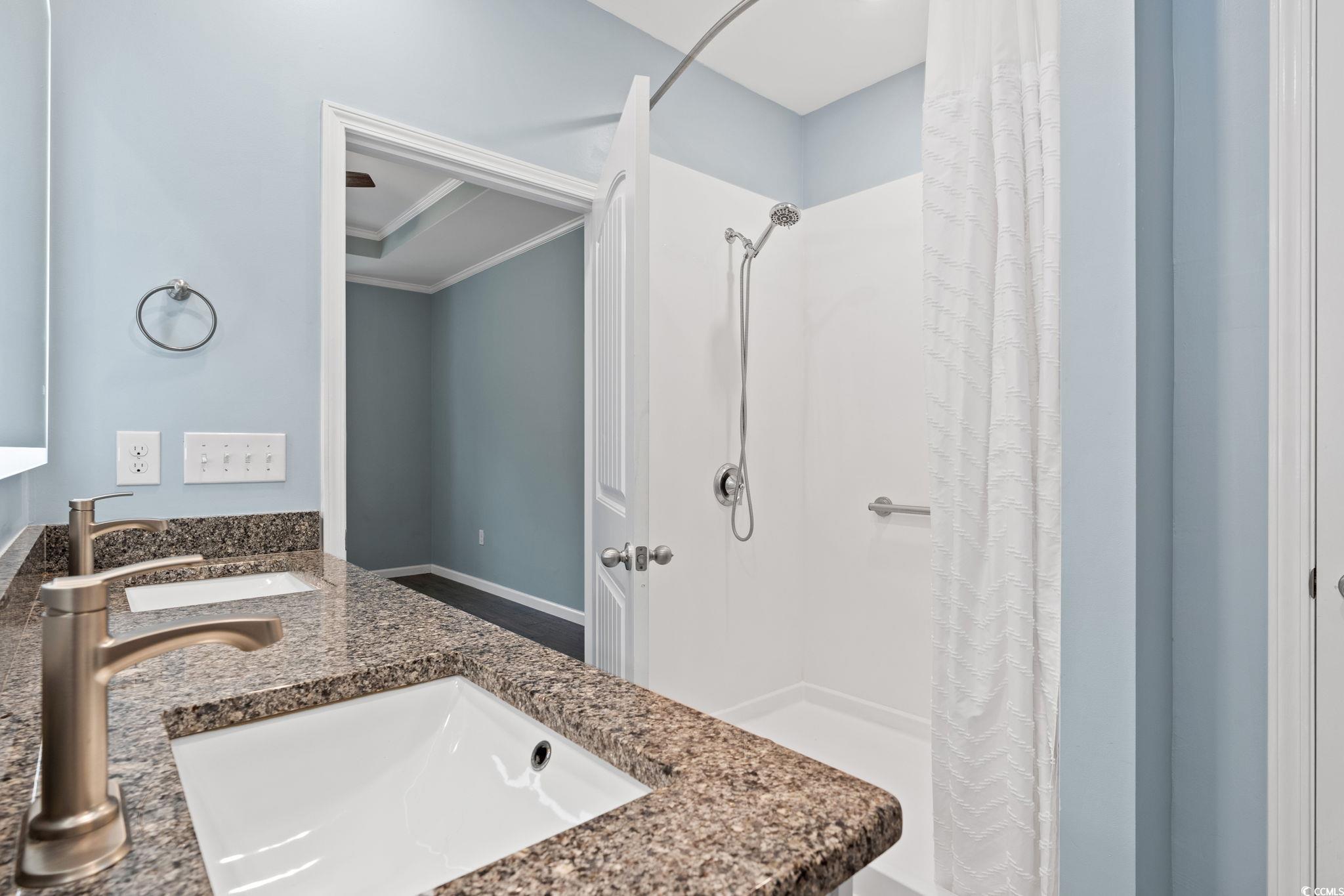 797 Salerno Circle, Unit C Myrtle Beach, SC 29579 - Photo 16 of 40 Bathroom with double vanity, a shower stall, and ornamental molding