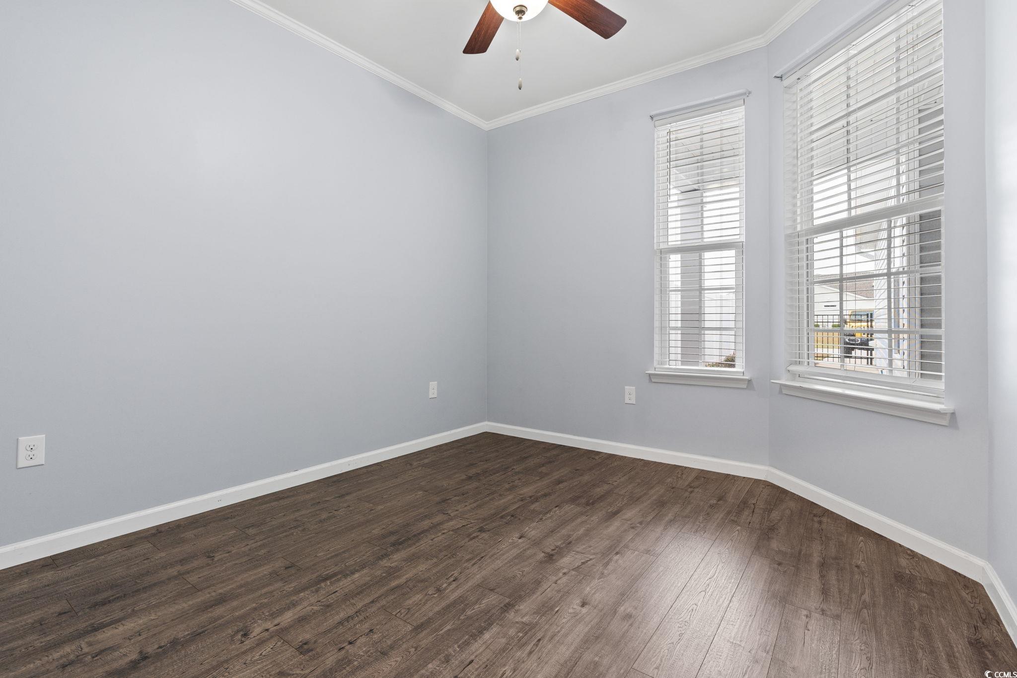 797 Salerno Circle, Unit C Myrtle Beach, SC 29579 - Photo 20 of 40 Spare room featuring crown molding, dark wood-style floors, and a ceiling fan