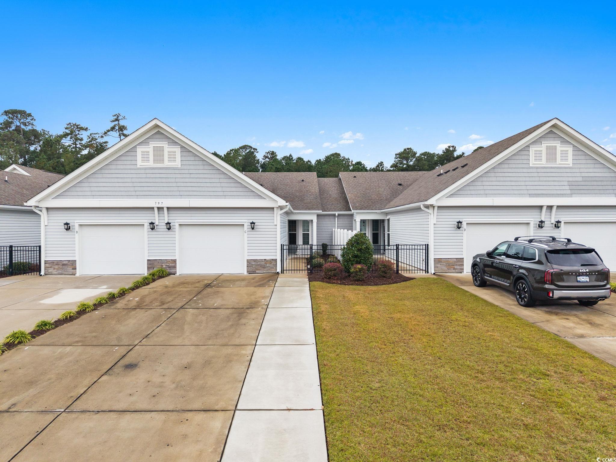 797 Salerno Circle, Unit C Myrtle Beach, SC 29579 - Photo 2 of 40 View of front of property featuring stone siding, driveway, and a shingled roof