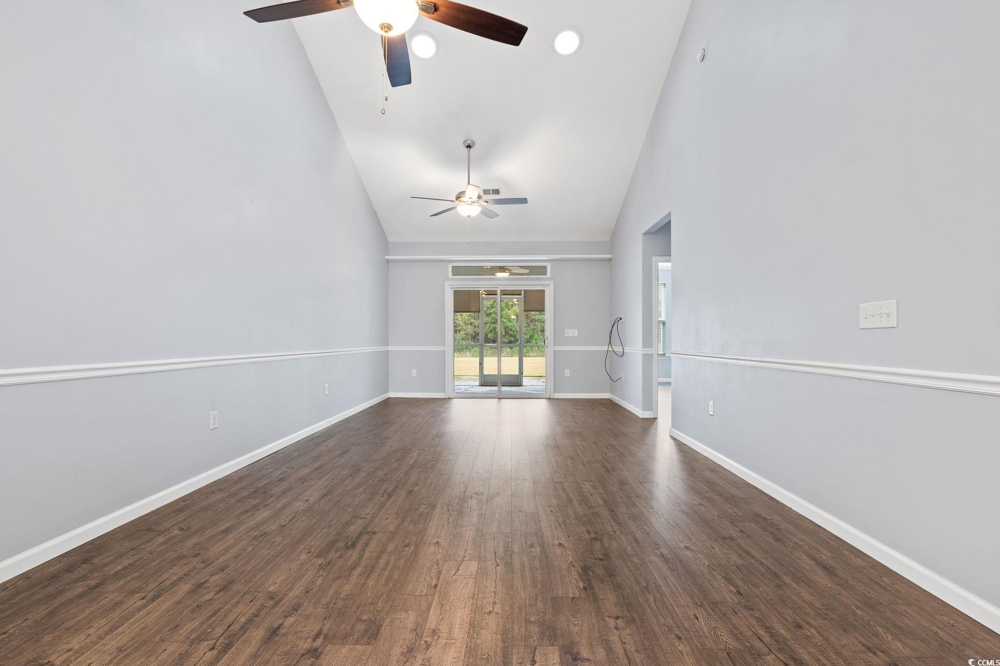 797 Salerno Circle, Unit C Myrtle Beach, SC 29579 - Photo 7 of 40 Empty room featuring high vaulted ceiling and dark wood-style floors