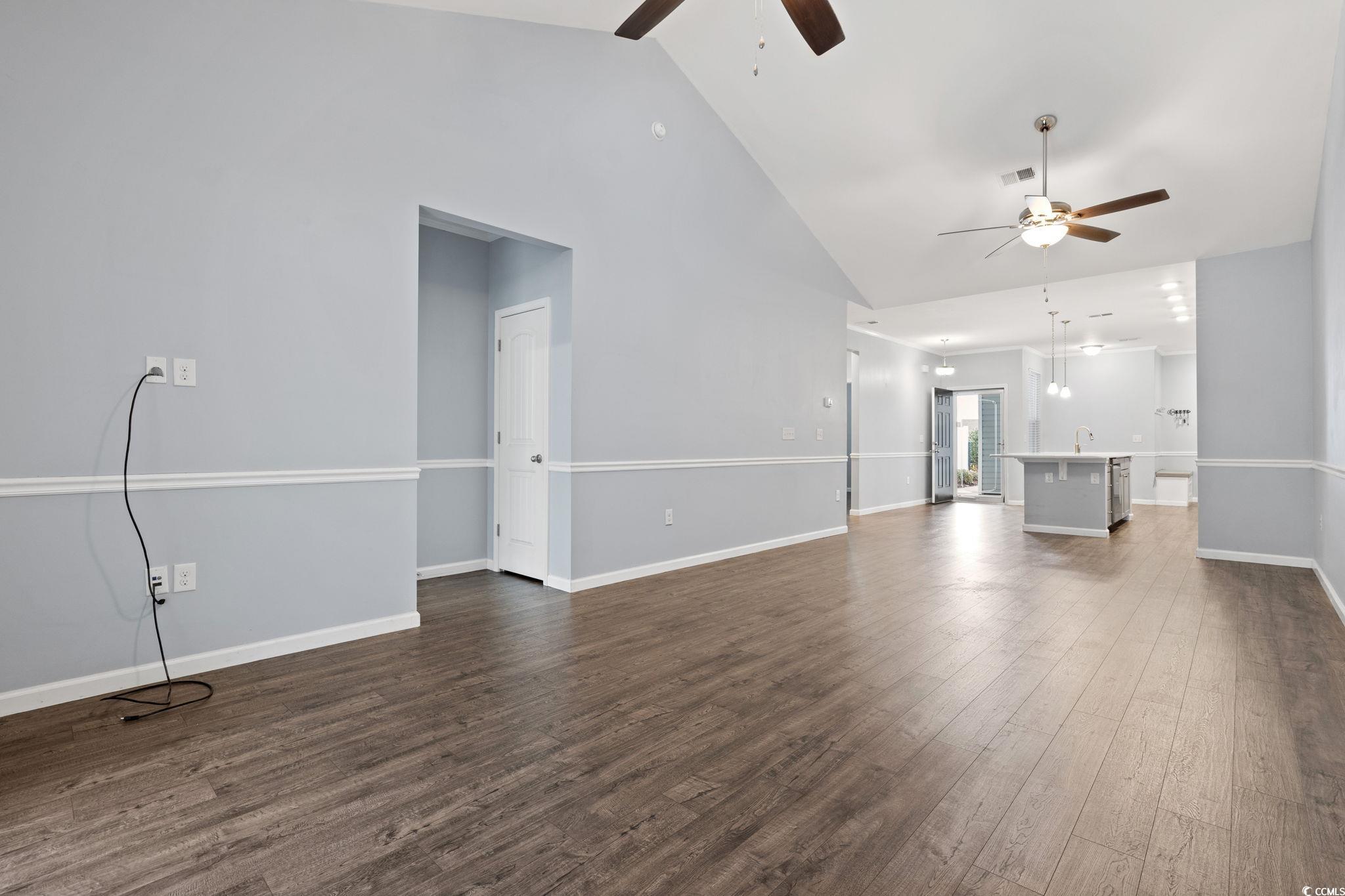 797 Salerno Circle, Unit C Myrtle Beach, SC 29579 - Photo 8 of 40 Unfurnished living room featuring a ceiling fan, dark wood-type flooring, and high vaulted ceiling