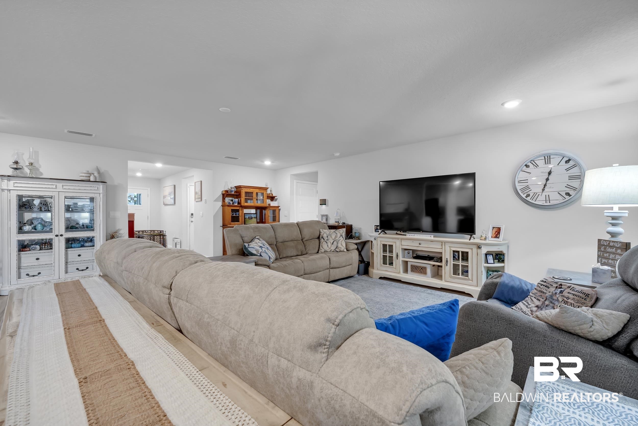 24271 Ringneck Loop Elberta, AL 36530 - Photo 5 of 44 Spacious living area featuring light-toned flooring, white walls, recessed lighting, and a prominent media console