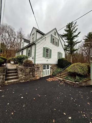 a bathroom with a toilet and a shower curtain