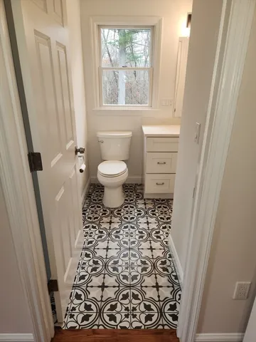 a view of a field with a trees in the background