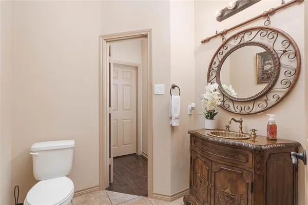 a bathroom with a toilet a sink and a mirror