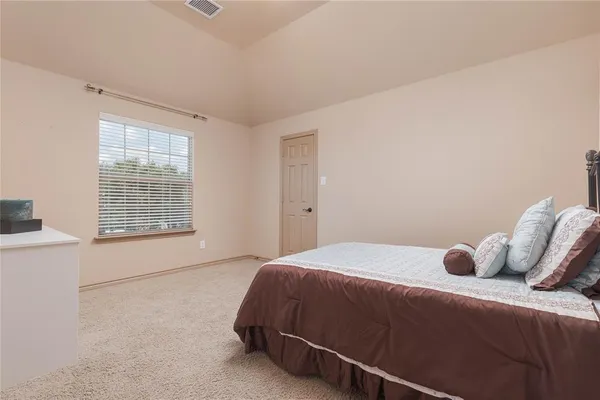 a bedroom with a bed and window