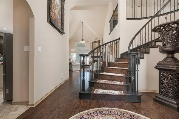 a view of entryway and hall with wooden floor