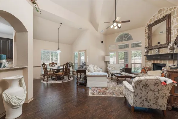a living room with fireplace furniture and a large window