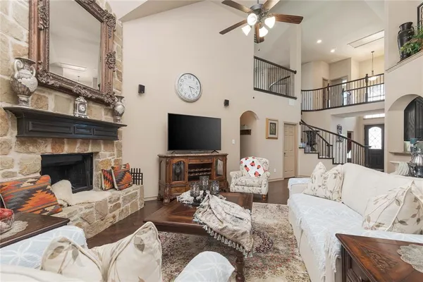 a living room with furniture a flat screen tv and a fireplace