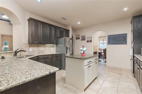 a kitchen with a sink stove and refrigerator