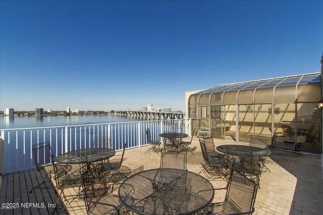 a view of a chair and tables in the balcony