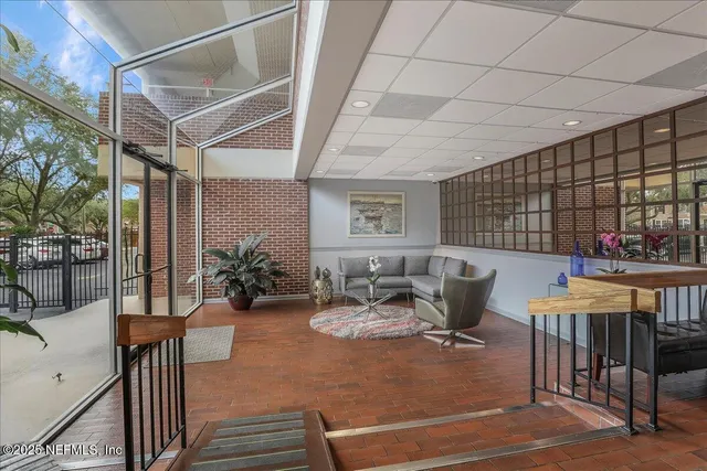 a view of a patio with a table and chairs and potted plants