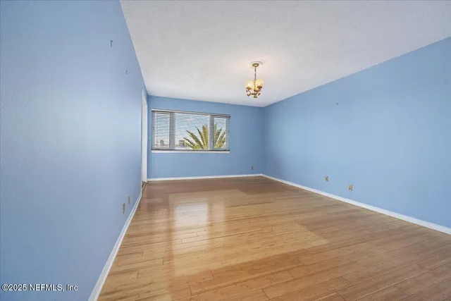 a view of an empty room and a window