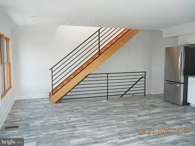a kitchen with wooden cabinets and stainless steel appliances
