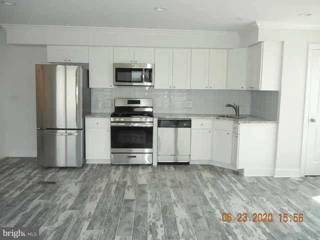 a stove top oven sitting inside of a kitchen