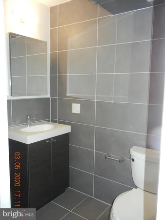 a bathroom with a sink toilet and a mirror