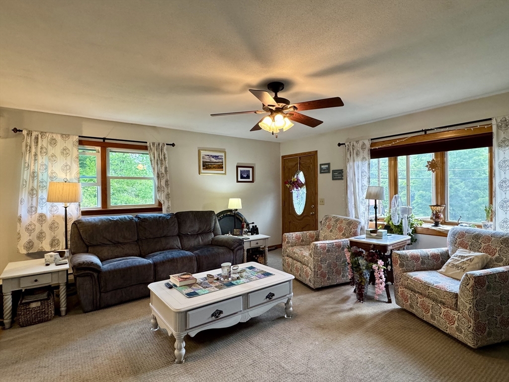 171 Haydenville Road Whately, MA 01093 - Photo 9 of 24 a living room with furniture ceiling fan and a large window