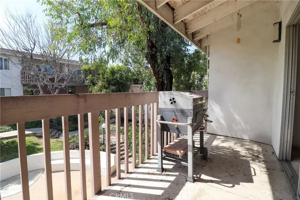 a view of a chairs and table in the balcony