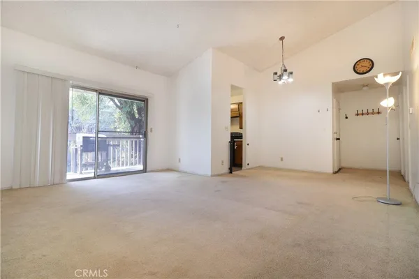 an empty room with windows and outdoor view
