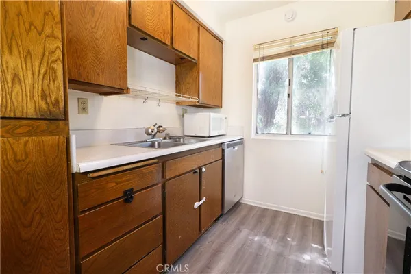 a utility room with wooden floor washer and dryer