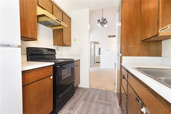 a kitchen with a sink stove and refrigerator