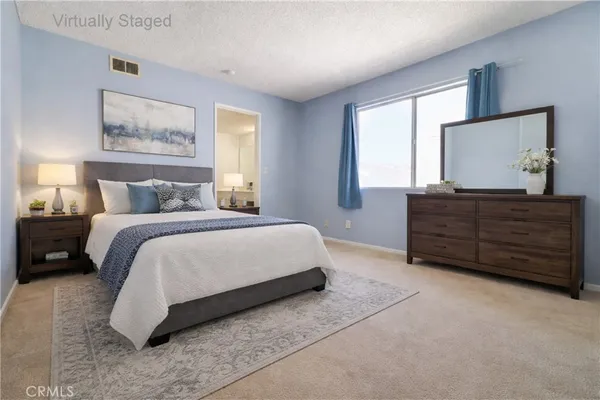 a bedroom with a bed and a dresser