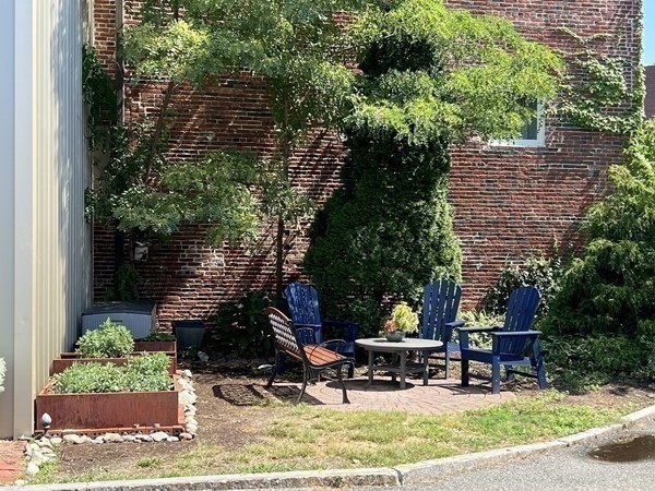 200 Market Street, Unit 4504 Lowell, MA 01852 - Photo 15 of 19 a view of patio with table and chairs and potted plants