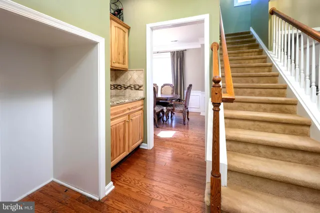 a view of a hallway view with wooden floor and staircase