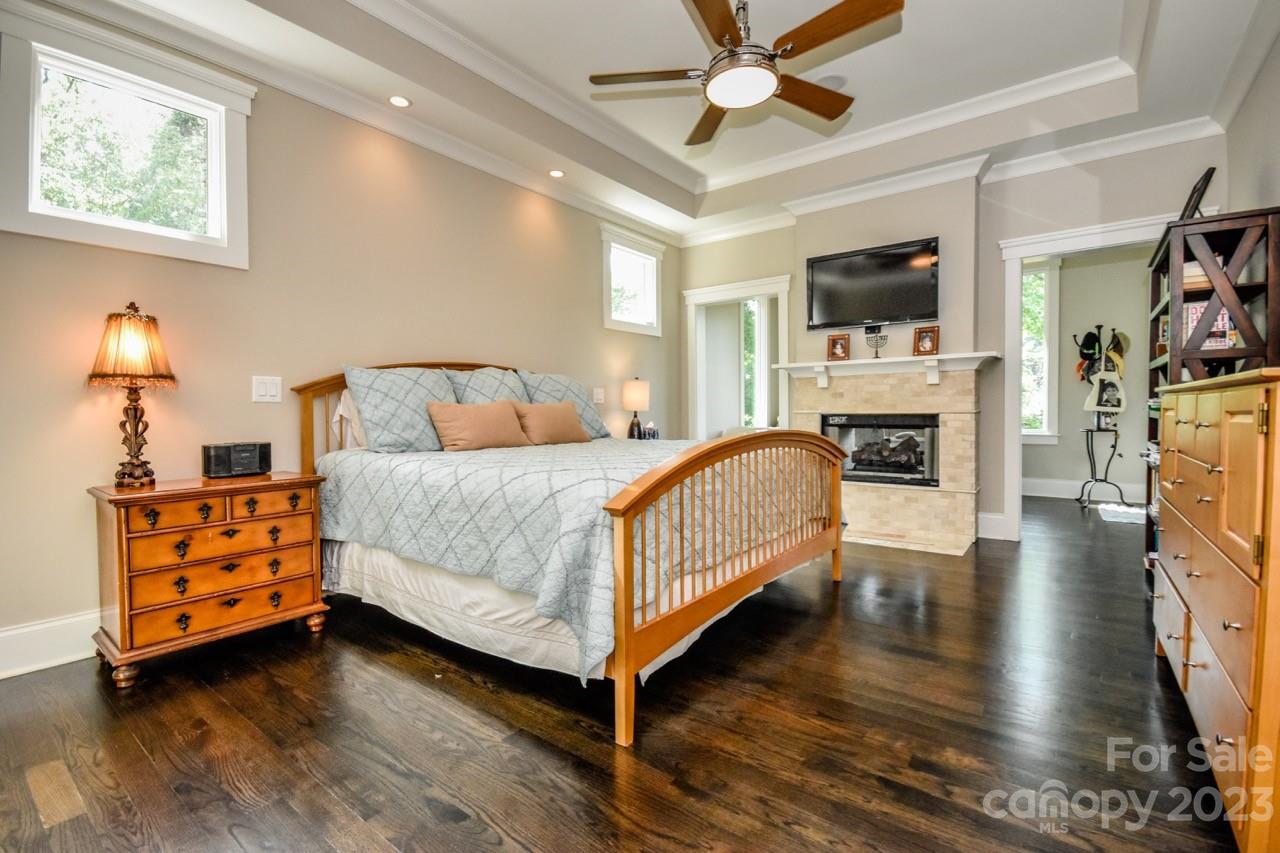 645 Kemp Road Mooresville, NC 28117 - Photo 13 of 48 a bedroom with a bed wooden floor and flat screen tv