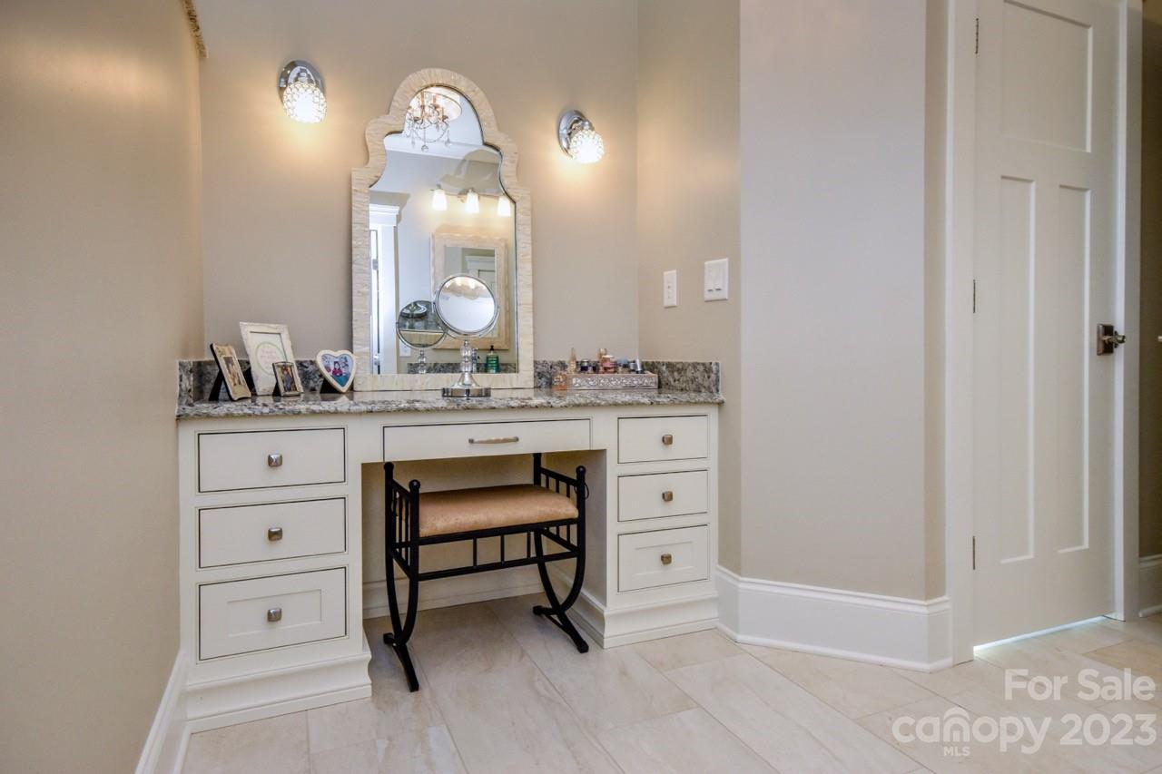 645 Kemp Road Mooresville, NC 28117 - Photo 17 of 48 a bathroom with a sink a vanity a lamp and a mirror