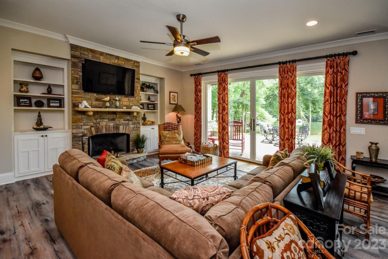 645 Kemp Road Mooresville, NC 28117 - Photo 30 of 48 a living room with furniture a flat screen tv and a fireplace