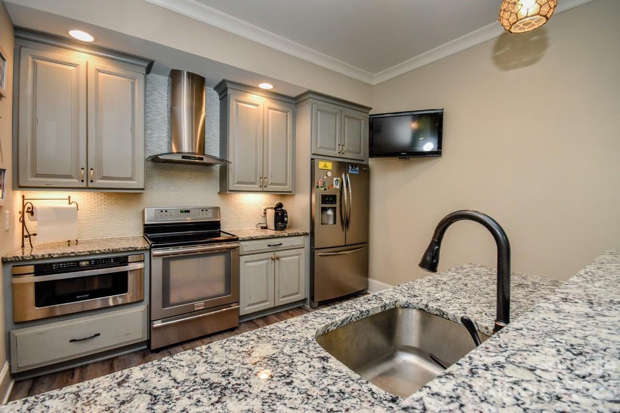 645 Kemp Road Mooresville, NC 28117 - Photo 33 of 48 a kitchen with a sink cabinets and stainless steel appliances