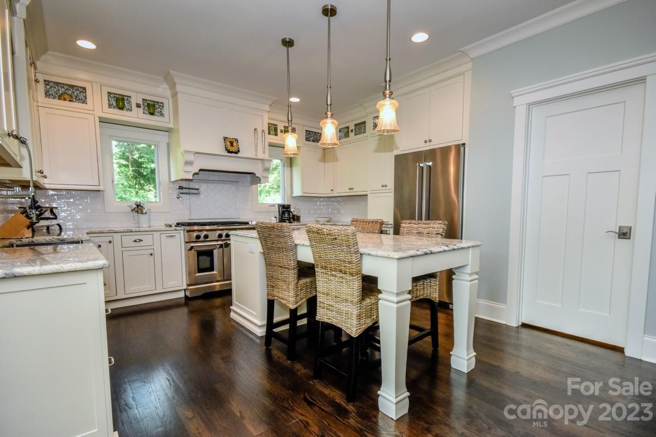 645 Kemp Road Mooresville, NC 28117 - Photo 5 of 48 a kitchen with stainless steel appliances a dining table chairs stove and cabinets