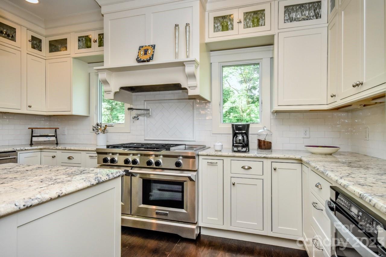 645 Kemp Road Mooresville, NC 28117 - Photo 6 of 48 a kitchen with stainless steel appliances granite countertop a stove and white cabinets