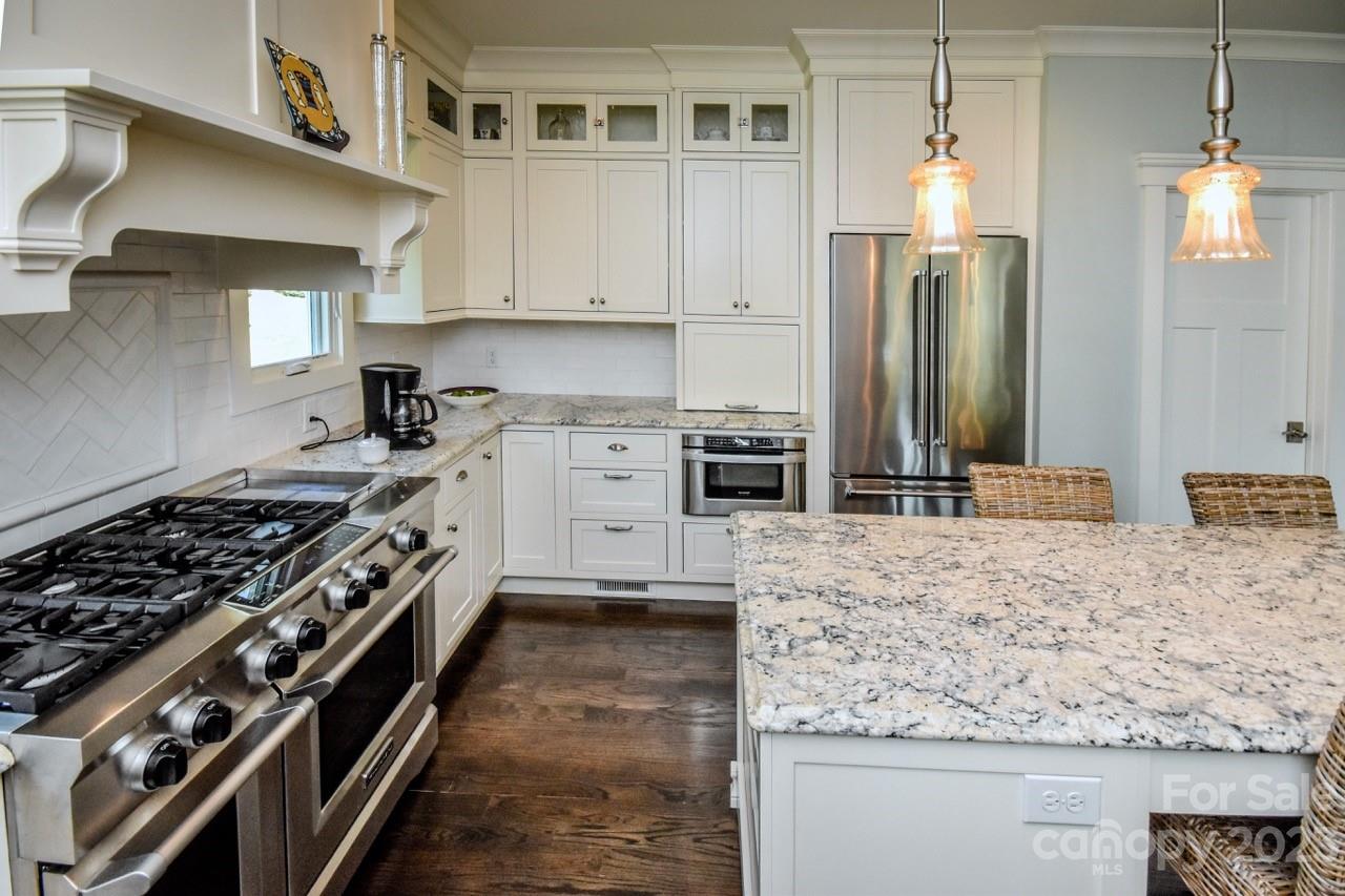 645 Kemp Road Mooresville, NC 28117 - Photo 8 of 48 a kitchen with stainless steel appliances granite countertop a stove and a refrigerator
